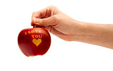 ripe red apple with the words "I love you" holding in hand
