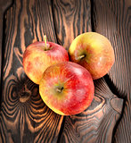 Red apples on the wooden table