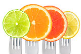 citrus fruit on forks isolated on white