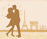 Romantic couple in Paris kissing near the Eiffel Tower