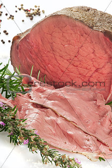 a still life of roastbeef on white