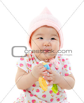 Asian baby girl gripping a toy