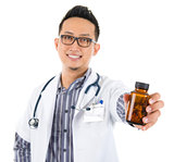 Asian medical doctor holding a bottle of pills