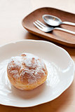 Choux pastry cream puffs on white plate