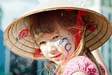 Portrait of a little girl with blue dragon on her cheek