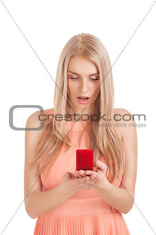 Surprised blond woman with ring in box