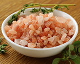 pink Hawaiian salt in a white bowl on a wooden table