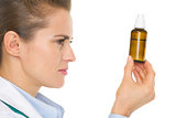 Medical doctor woman looking on medicine bottle