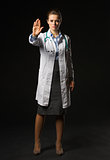 Full length portrait of medical doctor woman showing stop gestur
