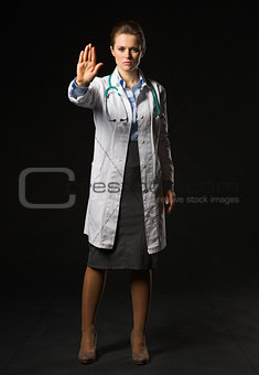 Full length portrait of medical doctor woman showing stop gestur