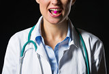 Closeup on medical doctor woman with tablet in mouth