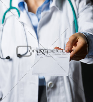 Closeup on medical doctor woman giving prescription isolated on 