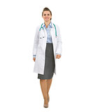 Full length portrait of medical doctor woman going straight
