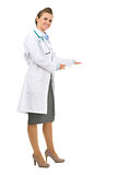 Full length portrait of medical doctor woman inviting to come