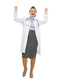 Full length portrait of happy medical doctor woman rejoicing suc