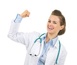 Happy medical doctor woman showing biceps