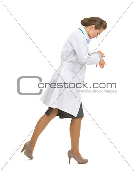 Busy medical doctor woman going sideways