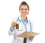 Portrait of medical doctor woman with clipboard and medecine bot