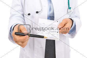 Closeup on medical doctor woman pointing on prescription