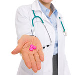 Closeup on medical doctor woman giving pills