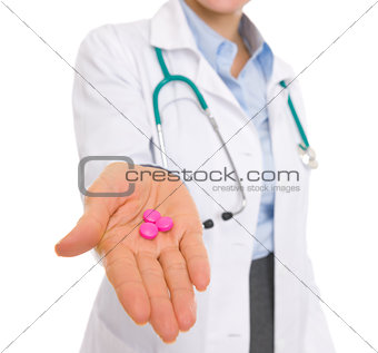 Closeup on medical doctor woman giving pills