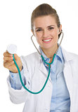Happy medical doctor woman using stethoscope