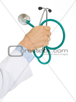 Closeup on medical doctor woman holding stethoscope