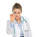 Medical doctor woman using syringe as darts