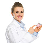 Smiling kosmetist woman pointing on creme