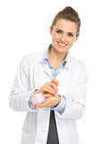 Smiling kosmetist woman applying creme on hand