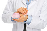 Closeup on kosmetist woman applying creme on hand