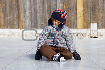 Boy learning to ice skate