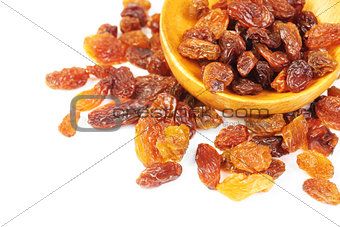 raisins and  wooden  spoon close- up  isolated on  white background 