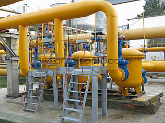 Natural gas station with yellow pipes power plant