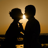 Sillhouette of kissing couple at sunset