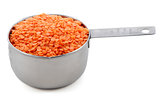 Red lentils presented in an American metal cup measure