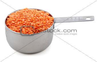 Red lentils presented in an American metal cup measure