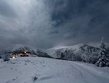 Night winter mountain landscape with house.