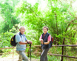 senior couple hiking in the nature with bamboo background