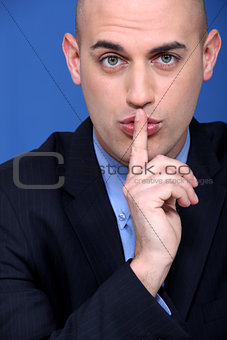 Man holding a finger to his lips