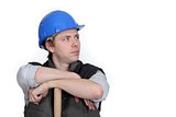 Worker resting on wooden stick