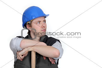 Worker resting on wooden stick