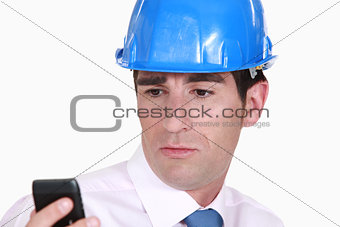 Architect looking at a cellphone