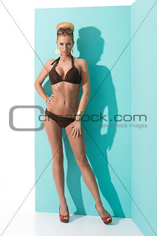 woman in bikini with sunglasses looks in to the lens