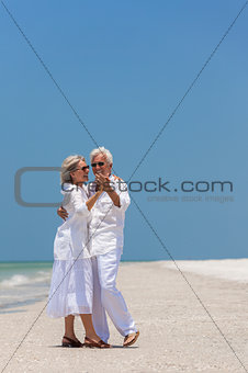 Happy Senior Couple Dancing on Tropical Beach
