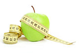 Green apple and measuring tape isolated on white background