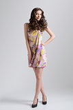 wavy brunette with colored dress in full-lenght