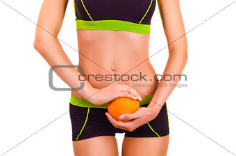 Slim figure of girl in a sportwear with orange in a hands