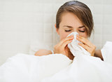 Woman with flu laying in bed