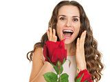 Surprised young woman receiving red roses